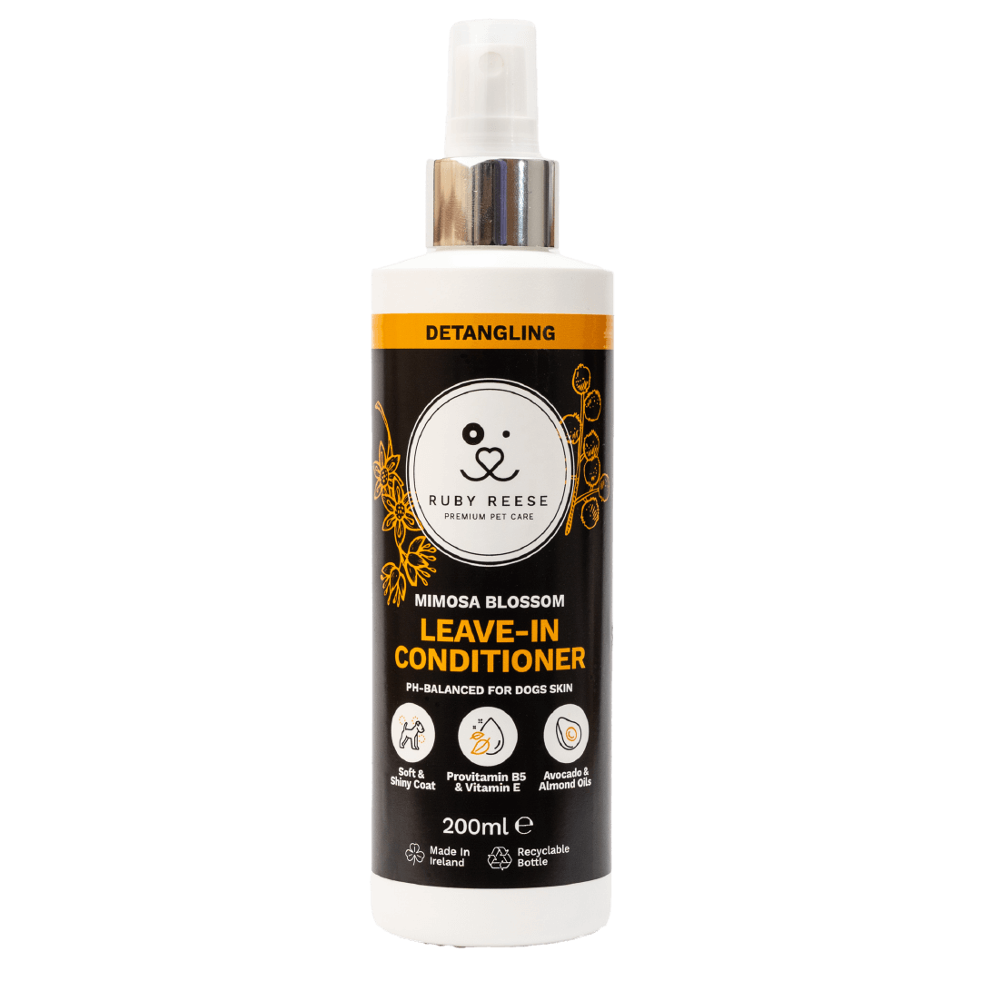 White bottle of RUBY REESE MIMOSA BLOSSOM LEAVE-IN CONDITIONER for dogs with a spray dispenser and a black label.