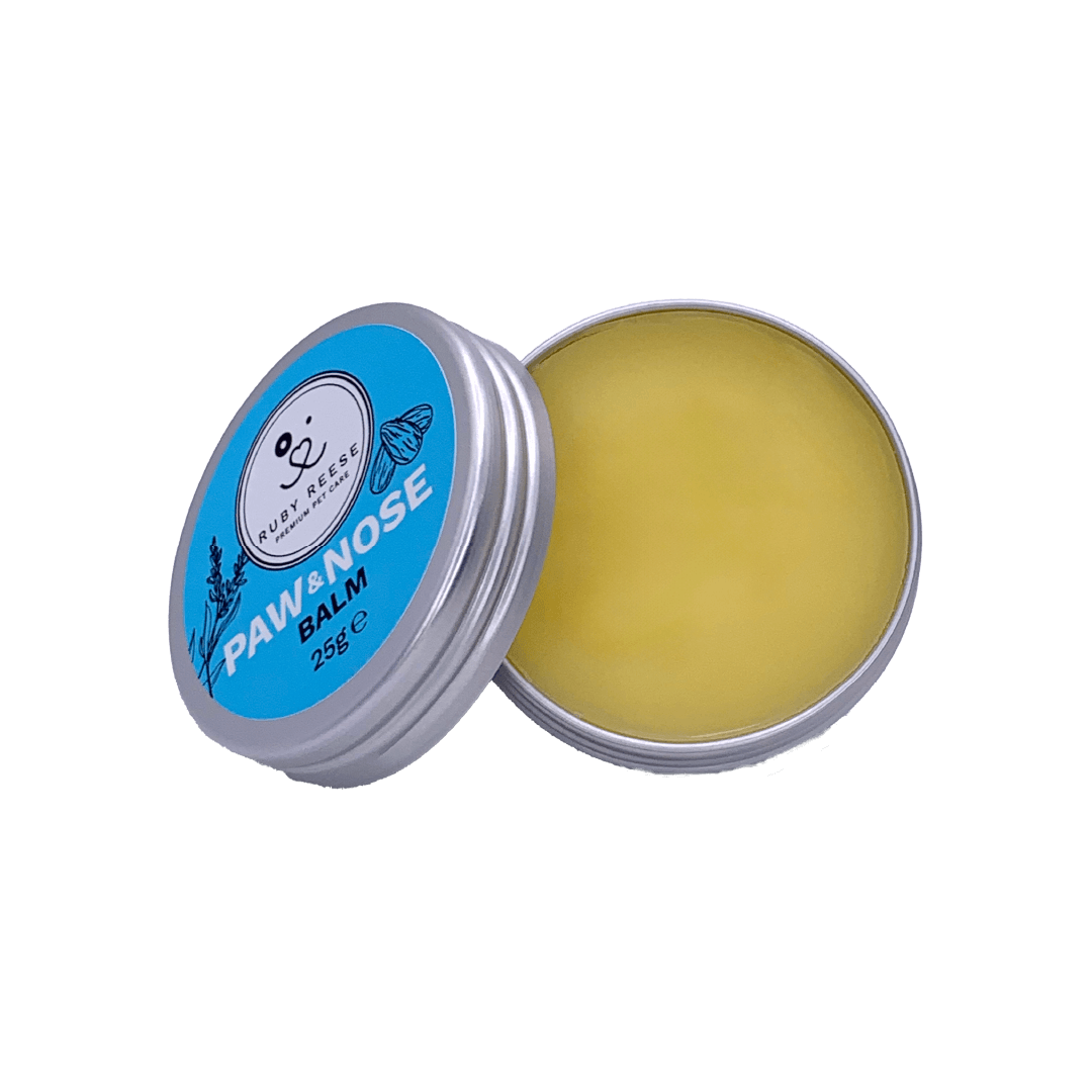 Small flat aluminium RUBY REESE PAW & NOSE BALM tin with an open lid and yellow balm with a matte surface in it