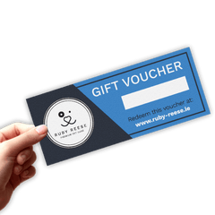 A hand is holding a blank RUBY REESE gift voucher