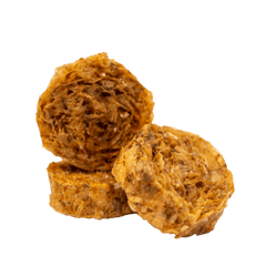 A group of three RUBY REESE CRISPY FISH BITES stacked on each other. They are round red dog treats made from 100% fish skin